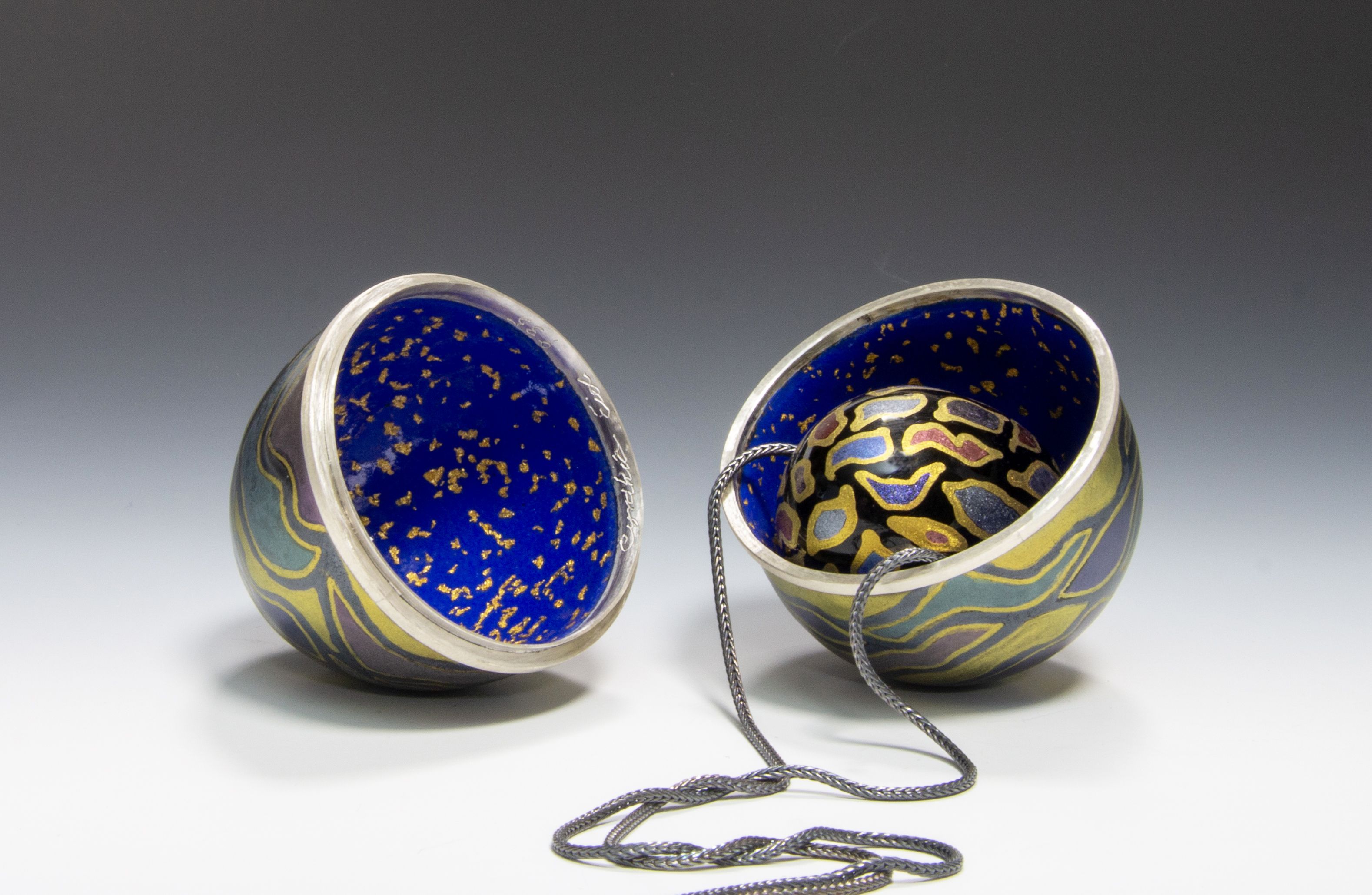 Enameled egg containing enameled pendant.  Cynthia Eid